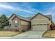 Charming single-Gathering home featuring a two-car garage and stone accents at 13744 Columbine St, Thornton, CO 80602