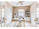 Stylish home office with modern desk, decorative rug, and built-in shelving at 13744 Columbine St, Thornton, CO 80602