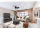 Comfortable living room with a large window, a white sofa, modern decor, and a ceiling fan at 13744 Columbine St, Thornton, CO 80602