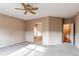 Expansive main bedroom with ensuite bathroom, neutral carpet, and ceiling fan at 13744 Columbine St, Thornton, CO 80602