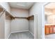 Spacious walk-in closet with ample shelving and natural light; en suite bathroom is visible through the doorway at 13744 Columbine St, Thornton, CO 80602
