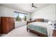 This bedroom features carpet flooring, a ceiling fan, light green walls, and lots of natural light at 291 Las Lomas St, Brighton, CO 80601