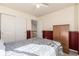 Spacious bedroom featuring neutral carpet, a ceiling fan, a bed, a closet and a wood-look accent wall at 291 Las Lomas St, Brighton, CO 80601