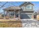 Charming two-story home with a well-manicured lawn and a two-car garage at 291 Las Lomas St, Brighton, CO 80601