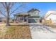 Charming two-story home with a well-manicured lawn and a two-car garage at 291 Las Lomas St, Brighton, CO 80601