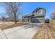 Charming two-story home with a well-manicured lawn and a two-car garage at 291 Las Lomas St, Brighton, CO 80601