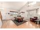 Spacious living room featuring hardwood floors and a large window at 291 Las Lomas St, Brighton, CO 80601