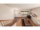 Spacious living room features wood flooring, a billiard table, a front door entryway, and natural light at 291 Las Lomas St, Brighton, CO 80601