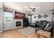 Cozy living room featuring a fireplace, large windows, and a comfortable sectional sofa at 291 Las Lomas St, Brighton, CO 80601