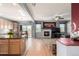 Open concept space combining a kitchen, dining area, and living room with a fireplace at 291 Las Lomas St, Brighton, CO 80601