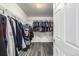 Spacious walk-in closet with ample hanging storage racks and gray wood-look flooring at 291 Las Lomas St, Brighton, CO 80601