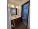 This bathroom features a vanity and mirror, as well as a shower and toilet enclosed by glass at 10064 W Lake Dr, Littleton, CO 80127