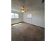 Comfortable bedroom featuring wall to wall carpet, two windows, and neutral color at 10064 W Lake Dr, Littleton, CO 80127