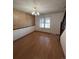 Bright dining room with light wood floors, classic chandelier, and decorative wallpaper accent wall at 10064 W Lake Dr, Littleton, CO 80127