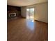 Cozy living room with brick fireplace and sliding glass doors to a deck and yard at 10064 W Lake Dr, Littleton, CO 80127