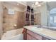Bathroom with a tub, tiled walls, and modern fixtures at 13001 Grant Cir # C, Thornton, CO 80241