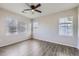 Spacious bedroom featuring laminate floors, ample windows, and a ceiling fan at 13001 Grant Cir # C, Thornton, CO 80241