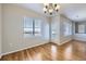 Bright dining room featuring hardwood floors, a chandelier, and a door to the outside at 13001 Grant Cir # C, Thornton, CO 80241