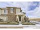 Inviting exterior of a two-story townhouse featuring a brick facade, covered entryway, and manicured landscaping at 13001 Grant Cir # C, Thornton, CO 80241