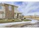 Charming two-story townhouse featuring a covered entryway, brick accents, and low maintenance landscaping at 13001 Grant Cir # C, Thornton, CO 80241