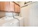 This laundry room features a washer and dryer, and built-in cabinets for storage at 13001 Grant Cir # C, Thornton, CO 80241