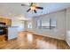 Living area with a kitchen, dining area, hardwood floors, and a view from the windows at 13001 Grant Cir # C, Thornton, CO 80241
