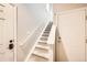 Carpeted staircase with white trim, offering a clean and well-lit path to the upper level of the home at 13001 Grant Cir # C, Thornton, CO 80241