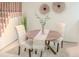 This home features a round dining table with seating for two and views of the stairs at 7751 S Curtice Dr # E, Littleton, CO 80120