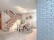 Cozy dining area features a round table with seating and stairs that lead to the upper level of the home at 7751 S Curtice Dr # E, Littleton, CO 80120