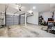 Spacious garage featuring two garage doors and some organizational shelving at 7751 S Curtice Dr # E, Littleton, CO 80120