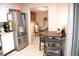Bright kitchen featuring stainless steel refrigerator and adjacent dining area with seating for four at 7751 S Curtice Dr # E, Littleton, CO 80120