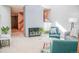 Bright living room features a painted brick fireplace, neutral walls, and comfortable furnishings at 7751 S Curtice Dr # E, Littleton, CO 80120