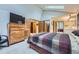 Spacious primary bedroom with a skylight, a large bed, and access to closets and en-suite bathroom at 7751 S Curtice Dr # E, Littleton, CO 80120