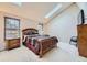 Serene main bedroom with natural light from skylight and windows, and a comfortable queen-sized bed at 7751 S Curtice Dr # E, Littleton, CO 80120