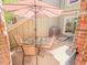 Cozy patio area with comfortable seating, a glass-topped table, and a grill at 7751 S Curtice Dr # E, Littleton, CO 80120