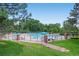 Community pool surrounded by lush landscaping and lounge chairs at 7751 S Curtice Dr # E, Littleton, CO 80120