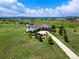 Stunning aerial view of estate home with lush landscaping and a golf course at 1935 Bashley Rd, Monument, CO 80132