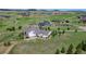 Idyllic estate with a sprawling home, surrounded by lush landscape and rolling hills at 1935 Bashley Rd, Monument, CO 80132