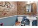 Stylish powder room with unique wallpaper, a pedestal sink, and a decorative mirror at 1935 Bashley Rd, Monument, CO 80132