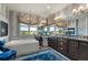 Spa-like bathroom with a soaking tub, dark wood cabinetry, and a chandelier at 1935 Bashley Rd, Monument, CO 80132