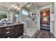 Modern bathroom with a glass-enclosed shower, granite countertops, and stylish fixtures at 1935 Bashley Rd, Monument, CO 80132