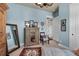 Bedroom featuring a decorative mirror, patterned chair, and unique artwork at 1935 Bashley Rd, Monument, CO 80132