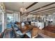 Open concept dining room featuring a wood table, exposed beams, and hardwood floors at 1935 Bashley Rd, Monument, CO 80132