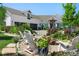 Landscaped front yard with Adirondack chairs, a fire pit, and colorful flower beds at 1935 Bashley Rd, Monument, CO 80132