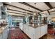 Elegant kitchen featuring an island with granite countertops, farmhouse sink, exposed beams and designer fixtures at 1935 Bashley Rd, Monument, CO 80132