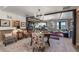 Bright living room featuring a chandelier, wood beam accents and an open floor plan at 1935 Bashley Rd, Monument, CO 80132