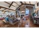 Open-concept living room featuring a stone fireplace and a comfortable seating area at 1935 Bashley Rd, Monument, CO 80132