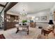 Open living area with wet bar, chandelier lighting, and detailed woodwork at 1935 Bashley Rd, Monument, CO 80132