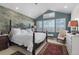 Bright main bedroom featuring a vaulted ceiling, large windows, and a cozy seating area at 1935 Bashley Rd, Monument, CO 80132