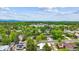 Aerial view of a neighborhood with tree-lined streets and mountain views in the distance at 6068 S Clayton St, Centennial, CO 80121